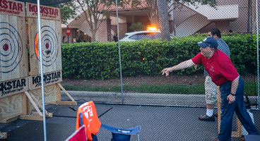 Mark Riccobono throws an ax at the Sports and Recreation Division game night.